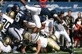 football players, clashing football players, dynamic action shot, American football game, athletes competing, football action, sports photography, football competition, football intensity, football collision, football players in action