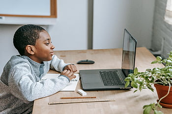 Black boy, online learning, laptop, notebook, modern education, home study, focused student, young boy, educational technology, home desk, digital learning
