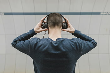 mies yllään kuulokkeet, takanäkymä, sisäympäristö, kuunnella musiikkia, harmaa pusero, pitkät hihat, kuulokkeet, mies sisätiloissa, taaksepäin, rento asu, Äänen kuuntelu
