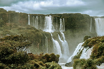 Iguazu Falls, Brazil, waterfalls, cloudy sky, vibrant rainforest, mist, breathtaking view, natural wonder, South America, travel destination, scenic landscape