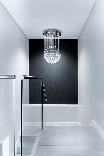 white downlight chandelier, sleek contemporary hallway, glass chandelier, minimalist design, modern lighting, hallway design, interior design, contemporary lighting, minimalist hallway, glass lighting, modern chandelier