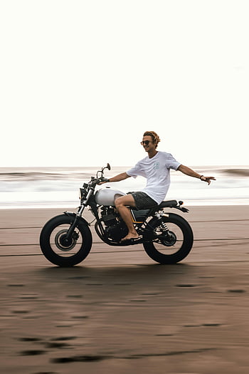man riding motorcycle, Bali beach, carefree motorcycle ride, young man, leisure, adventure, motorcycle, beach, outdoor activity, travel, vacation