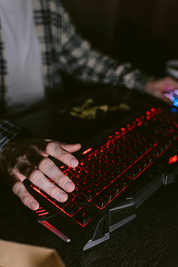 backlit mechanical keyboard, gaming keyboard, technology themes, close-up hands, computer keyboard, gaming setup, red backlight, ergonomic keyboard, typing hands, desk setup, keyboard gaming