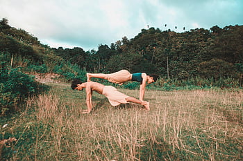 couple doing yoga, acro yoga, balance, fitness, natural setting, field, outdoor yoga, partner yoga, acrobatic yoga, outdoor fitness, nature yoga