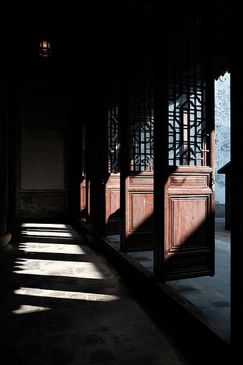 wooden doors, old temple, sunlight, intricate shadows, ancient doorway, temple interior, traditional architecture, historic building, cultural heritage, natural light, architectural details
