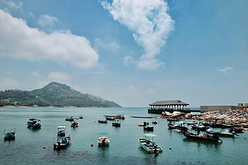 boats on the dock, Hong Kong harbor, serene harbor, docked boats, clear blue sky, Hong Kong boats, harbor scenery, calm water, boat dock, Hong Kong waterfront, scenic harbor