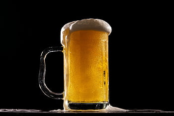 cold beer, frothy foam, glass mug, black background, close-up shot, refreshing drink, beer mug, overflow foam, golden beer, beer glass, dark backdrop