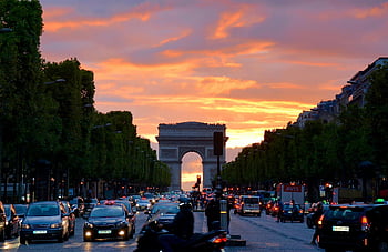 Arc de Triomphe, Parisian traffic, sunset sky, crowded street, Paris architecture, vivid sunset, cityscape, urban scene, evening traffic, iconic monument, French landmark