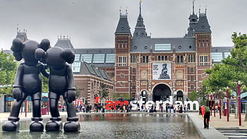 Amsterdam Building, Rijksmuseum facade, modern art sculptures, reflection, Amsterdam, KAWS sculptures, museum entrance, outdoor art, city landmark, cultural attraction, urban architecture
