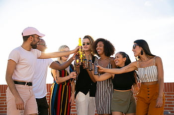 Amici multirazziali, applauso, bottiglie di birra, terrazza, Gruppo eterogeneo, godersi le bevande, all'aperto, Toast allegro, ritrovo sociale, amicizia, celebrazione