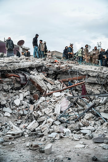 destroyed city, earthquake aftermath, Jindires, Aleppo Governorate, Syria, rubble inspection, disaster relief, rescue workers, collapsed buildings, natural disaster, human resilience