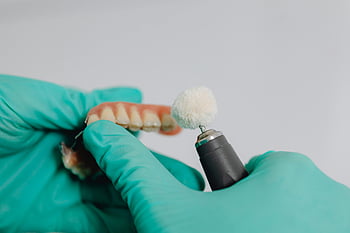 dentist, gloves, polishing, teeth implants, dental prosthetic, specialized tool, clinical setting, dental care, dental hygiene, dental equipment, dental professional