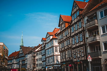 traditional half-timbered houses, sunny day, Hanover Germany, scenic view, blue sky, clear sky, red roofs, historic architecture, urban landscape, European city, half-timbered buildings