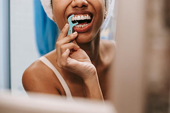 oral hygiene, flossing teeth, African American woman, bathroom mirror, dental care, young woman, tooth care, dental hygiene, dental floss, personal care, reflection