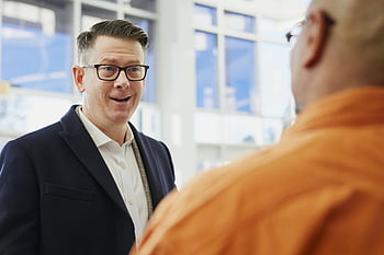 business professionals, conversation, office setting, two men, focus photography, professional attire, office environment, business discussion, corporate interaction, workplace dialogue, formal meeting