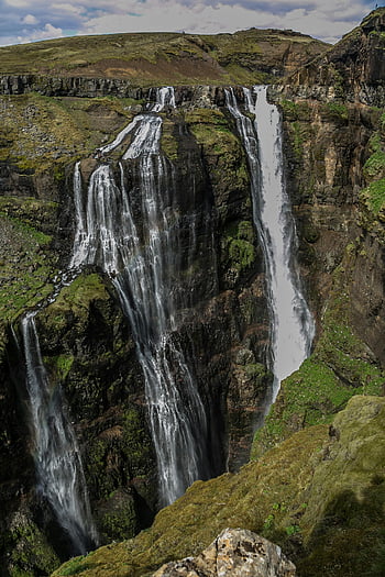 waterfall, nature photography, rugged cliffs, lush greenery, scenic landscapes, flowing water, natural beauty, outdoor scenery, cascading water, cliffside view, green landscape
