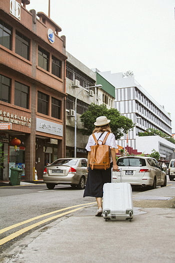 woman, city street, suitcase, backpack, sunny day, busy street, urban scene, travel, walking, street view, city life