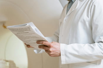 doctor, white coat, medical papers, healthcare setting, medical analysis, medical consultation, healthcare professional, patient documents, medical review, examination, hands