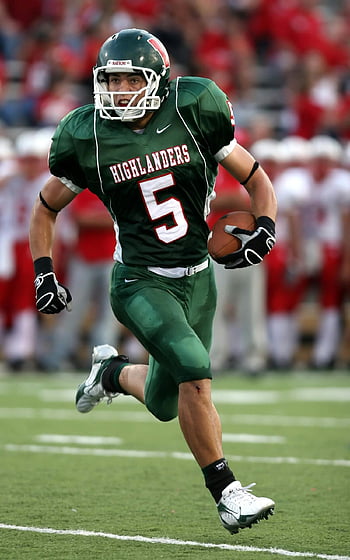 high school football, green uniform, running with ball, football game, highlanders jersey, American football, player in action, sports field, football player, green jersey, running player