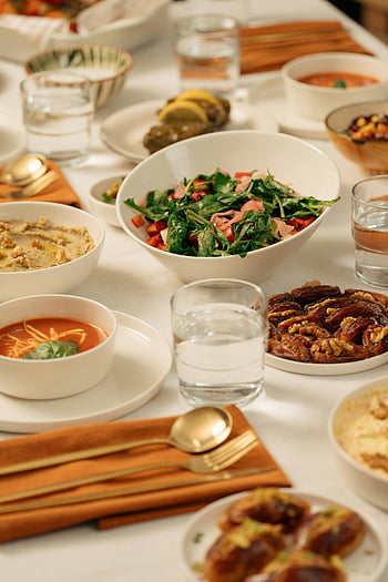 Ramadan, iftar, Middle Eastern dishes, table setting, cutlery, salad, dates, soup, water glasses, festive meal, dining table