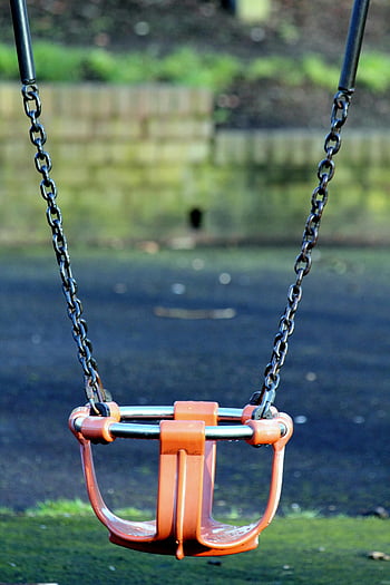 orange and gray bucket swing, outdoor park playground, empty swing, solitude, childhood nostalgia, playground equipment, swing set, outdoor recreation, park swing, children's playground, swing seat