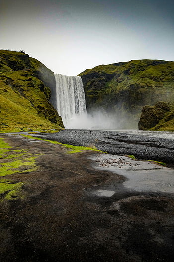 Skógafoss waterfall, Iceland, lush green hills, daytime, breathtaking view, natural landscape, outdoor scenery, travel destination, Skógafoss, waterfalls, nature photography