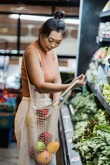 Asian woman, supermarket, groceries, fruits, vegetables, reusable mesh bag, shopping, produce aisle, eco-friendly, sustainable shopping, grocery store