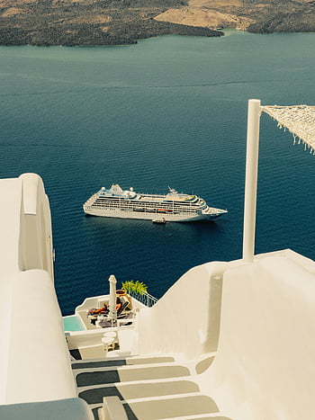 cruise ship, Santorini, coastal town, serene view, white buildings, iconic architecture, Mediterranean sea, luxury travel, vacation destination, Greek islands, seaside scenery
