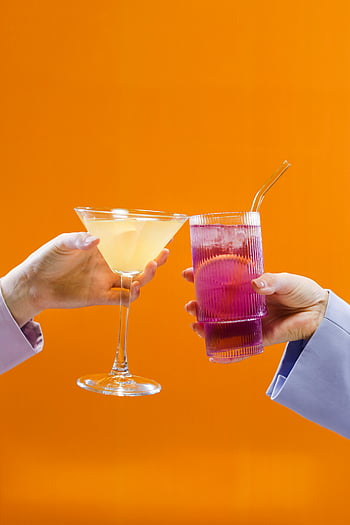 cocktails, glass, toast, orange background, celebration, colorful drinks, raised glasses, vivid colors, party theme, festive drinks, cheers