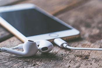 Gold iPhone 7, Lightning Earpods, smartphone, earphones, wooden surface, technology, connectivity, close-up image, mobile device, audio accessories, tech gadgets