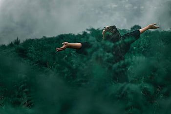 woman, open arms, grass field, foggy landscape, enjoying freedom, green landscape, outdoor scene, natural setting, serene moment, open hands, misty environment