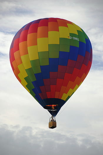 hot air balloon, multi colored, vibrant rainbow, cloudy sky, adventure, freedom, daytime, aerial view, colorful balloon, outdoor activity, sky travel