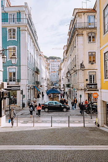 busy people, pedestrian lane, Lisbon, Bairro Alto, urban scene, vibrant street, historic neighborhood, city life, street crossing, European city, architecture