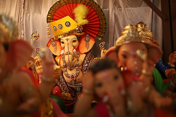 Ganesh idols, Indian festival, cultural artistry, vibrant Ganesh, festival celebration, beautiful idol, lord Ganesha, procession, cultural display, traditional art, festival decoration
