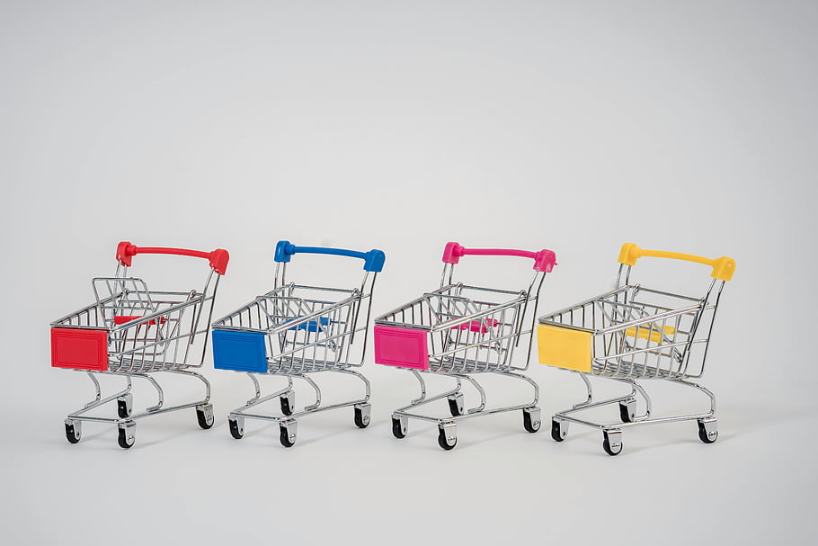miniature shopping carts, colorful push carts, neutral background, close-up photo, assorted colors, shopping cart row, miniature carts, colorful carts, shopping carts, neutral backdrop, close-up image