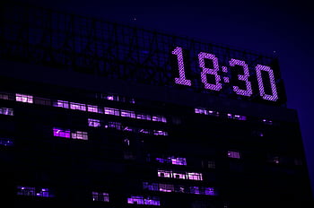 digital clock, modern building, illuminated night, prominent display, 18:30 time, urban architecture, nighttime scene, large building, digital time display, cityscape night, architectural lighting
