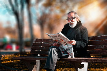 man reading newspaper, senior man, beard, wooden bench, sunny park, outdoor setting, newspaper reader, elderly man, park scene, autumn leaves, glasses