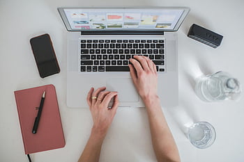 macbook air, bærbar, smartphone, notesbog, skrivebord, overhead view, person, der bruger bærbar computer, arbejdsområde, produktivitet, teknologi, hænder skrive