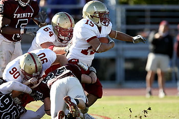 football players, American football, intense match, teamwork, determination, on the field, sports action, athletic competition, game day, team spirit, sportsmanship