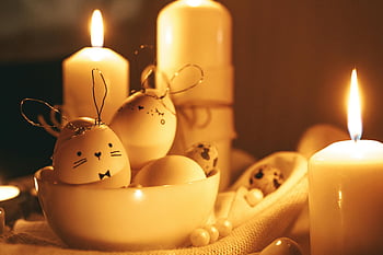 Easter, lighted candles, painted eggs, golden background, cozy ambiance, bunny designs, warm setting, Easter eggs, Easter candles, Easter decor, Easter bunny