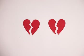 broken paper hearts, red broken hearts, white background, heartbreak symbol, separation symbol, two broken hearts, red heart shapes, emotional imagery, love loss, broken heart art, heartbreak concept
