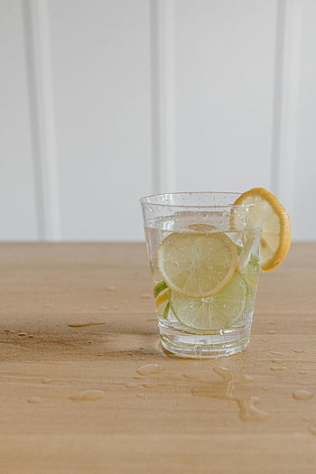 glass of lemonade, lemon slices, lime water, refreshing drink, healthy drink, wooden table, chilled glass, lemon and lime, citrus drink, summer beverage, hydration