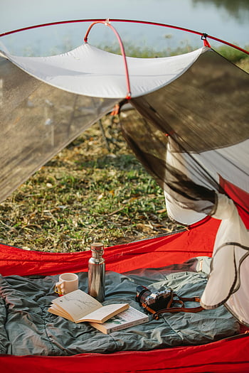 camp tent, books, thermos bottle, nature, peaceful camping, lake, camera, outdoor, camping scene, tent interior, camping gear