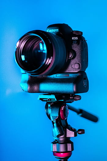 DSLR camera, close-up photo, Canon EOS, tripod, blue background, camera lens, photography equipment, camera gear, professional camera, camera setup, camera tripod