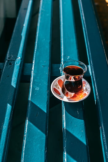 Turkish tea, glass of tea, street, vibrant photo, traditional Turkish tea, colorful terrace, Istanbul, cultural essence, blue bench, outdoor setting, tea culture