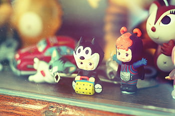 intage toy figurines, plastic toys, wooden shelf, glass display case, close-up, retro toys, collectible toys, toy collection, nostalgic toys, display case, figurines