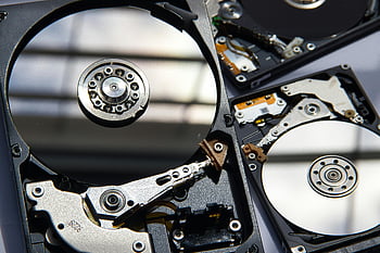 mechanical hard drive, flat surface, disassembled hard drives, technology components, hardware components, detailed view, storage device, internal components, computer hardware, data storage, magnetic disk