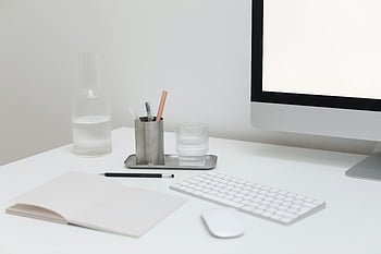 minimalist workspace, modern computer, notepad, glassware, stylish desk, office supplies, gadgets, white desk, computer monitor, keyboard, mouse