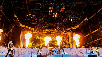band playing, stage, fire, concert, live performance, musicians, stage lights, rock band, stage effects, music event, performance art