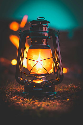 lighted lamp, classic lantern, warm glow, night setting, illuminated lantern, outdoor lighting, vintage lamp, camping light, evening ambiance, portable light, outdoor lamp